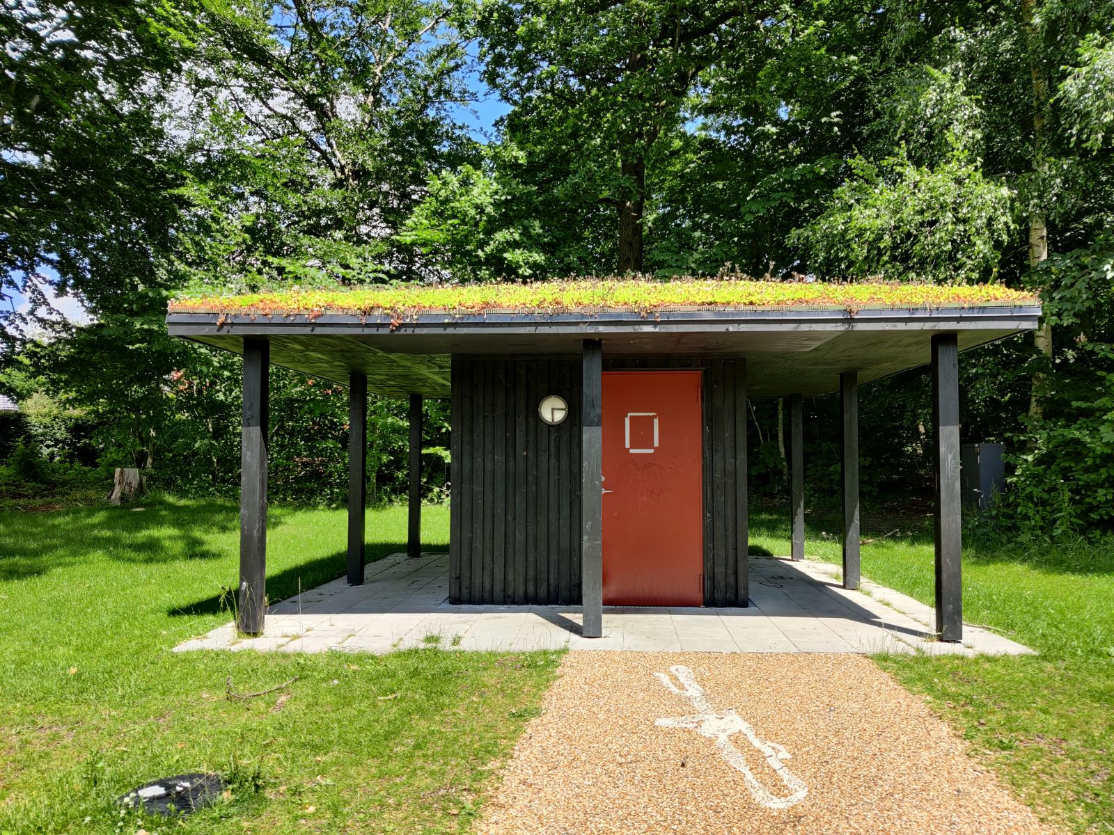 Adgangsvejen til toilettet med fast belægning