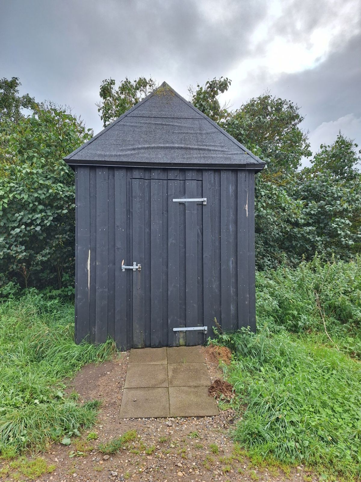Multtoilettet set med lukket dør. Døren åbner udad og mod højre. Døren er med stalddørsgreb. 