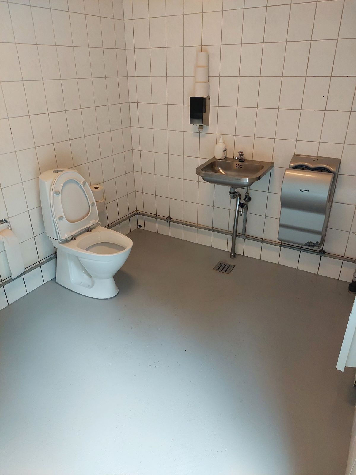 På handicaptoilettet er der håndvask, håndtører.